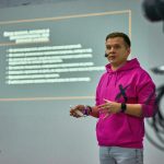 A man standing in front of a projection screen
